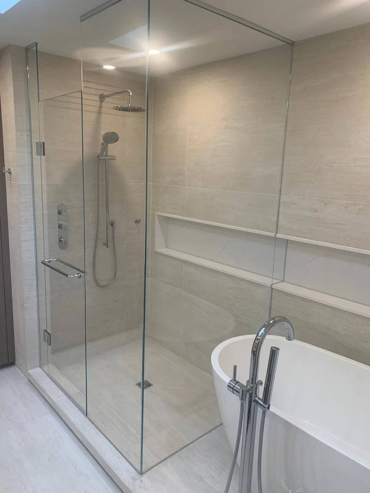 Frameless glass shower enclosure installation